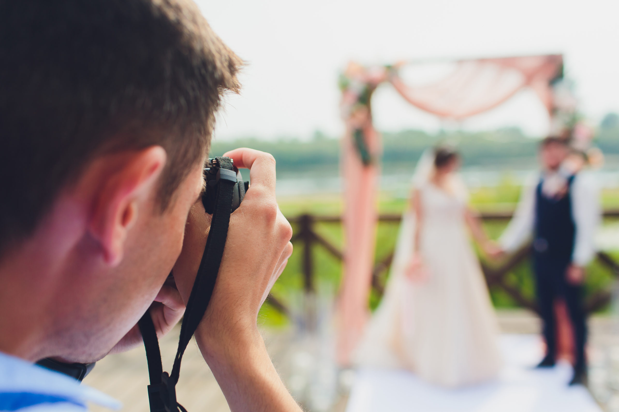 Wedding Photographer Takes Pictures Of Bride And Groom In City Wedding Couple On Photo Shoot