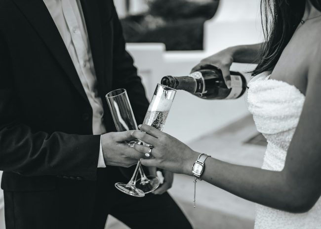 a couple of people that are holding wine glasses