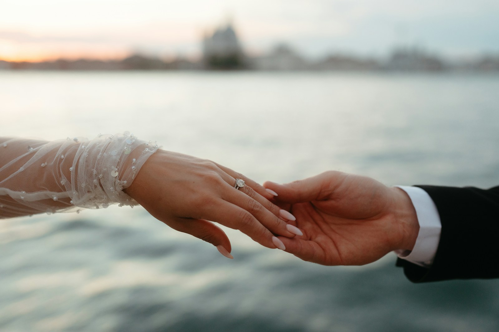 A close up of a person holding another person's hand