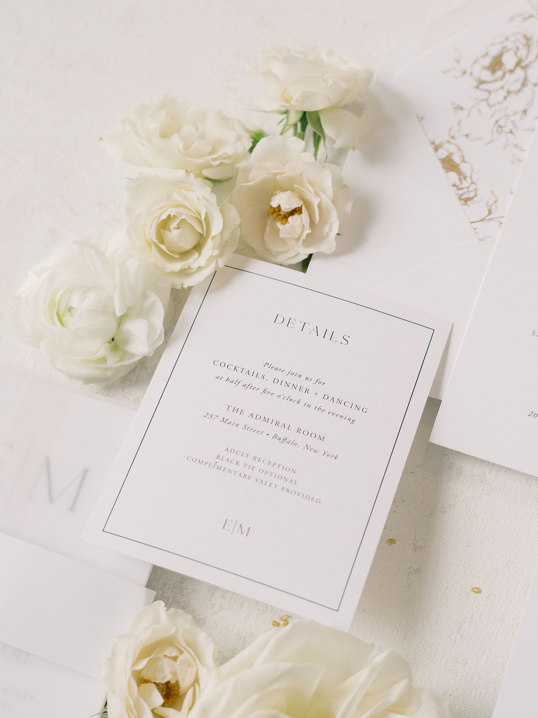 Wedding invitation with white roses on a white table