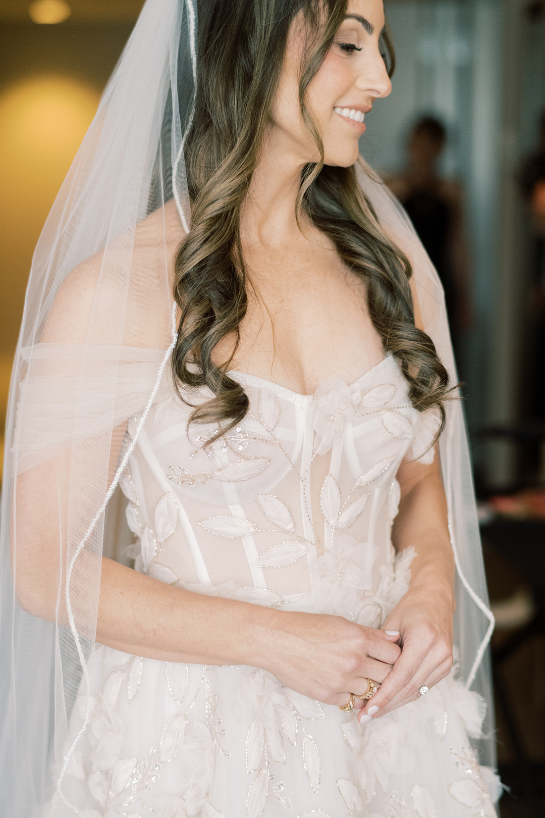 Bride in a beaded corset gown and veil