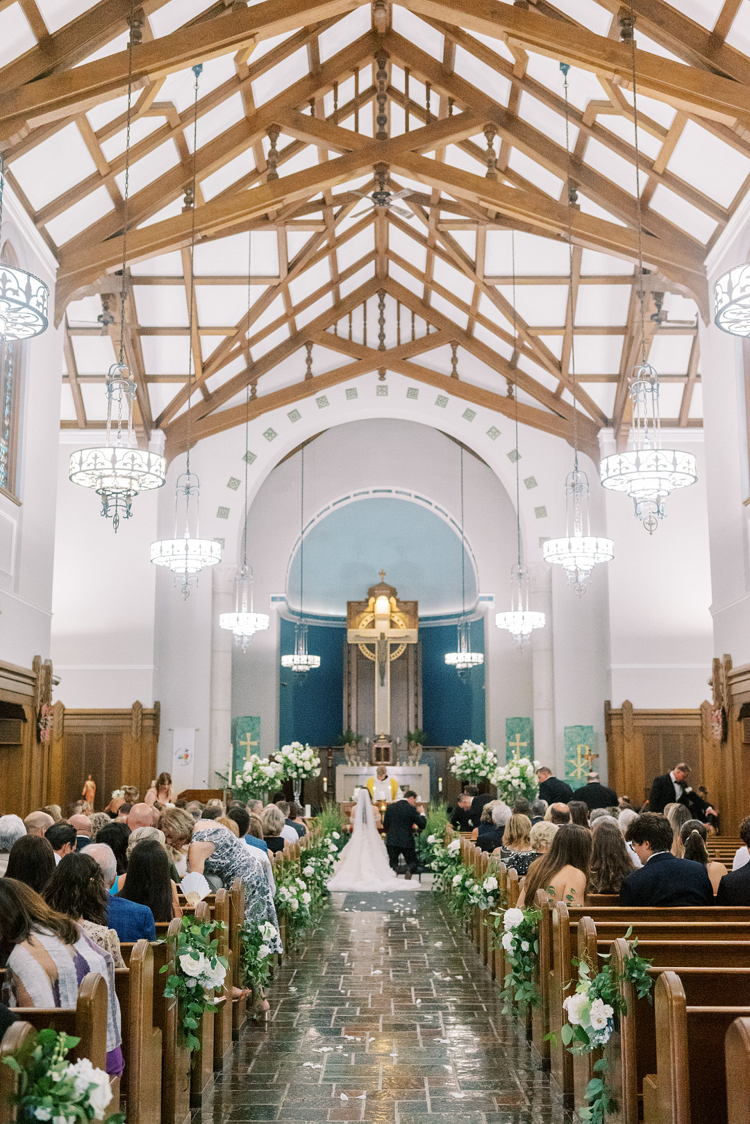 Wedding ceremony in a church with a vaulted wooden ceiling