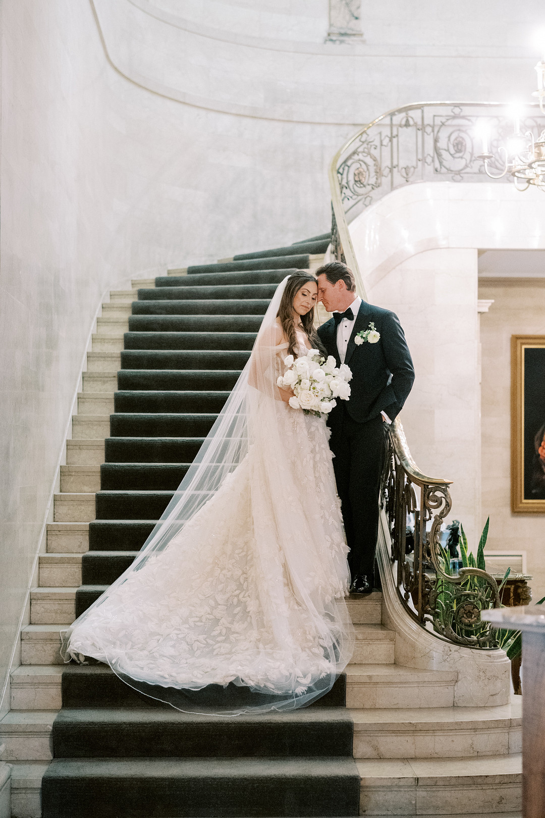 Bride and groom on a grand stone staircase