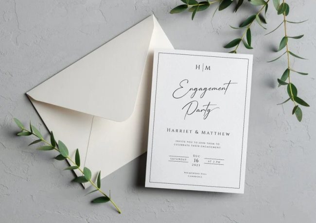 BetsyLilyDesigns minimal engagement party invitation with a thin black border, beside an envelope