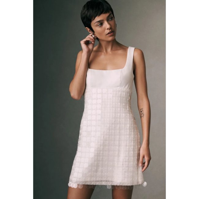 Model in the BHLDN blush sequin mini dress with a square neckline and wide straps