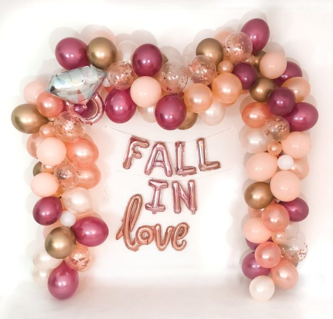 CherCanDoIt balloon garland in burgundy, blush, rose gold and gold around rose gold Fall in Love letter balloons