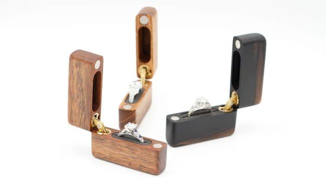 ConcealableMomentsUS slim hinged ring boxes in light and dark woods, two standing open with rings
