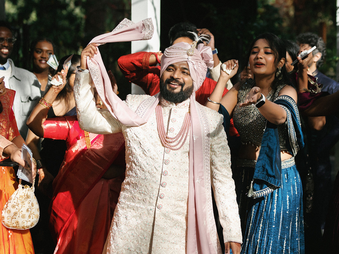 Groom dancing with guests during his arrival