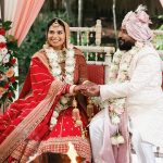 Bride and groom seated in the mandap during their Indian wedding ceremony
