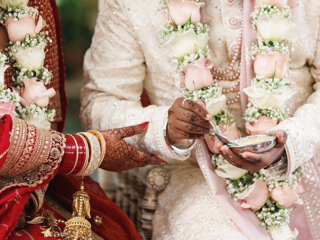 Close-up of the couple's flower garlands during the ceremony