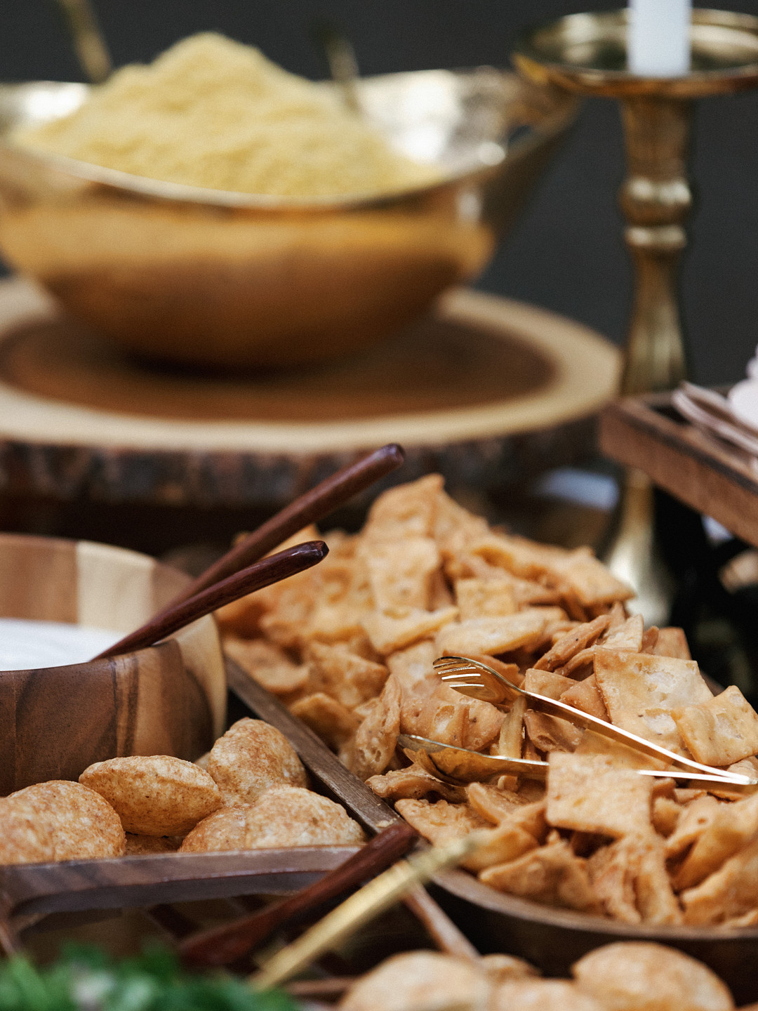 Brass bowls of snacks and sweets on the dessert table