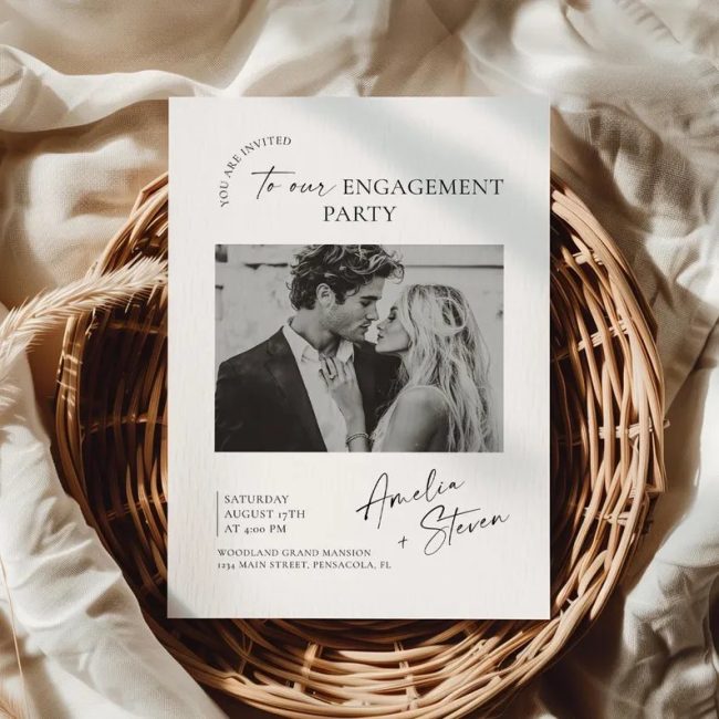 EdiDesignCollection engagement party invitation with a black-and-white couple photo, propped in a basket