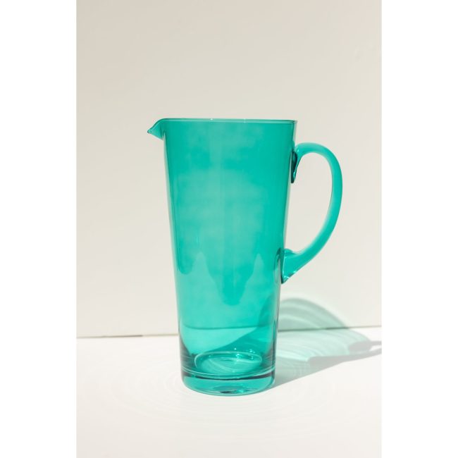 Estelle Colored Glass drink pitcher in emerald green with a rounded handle