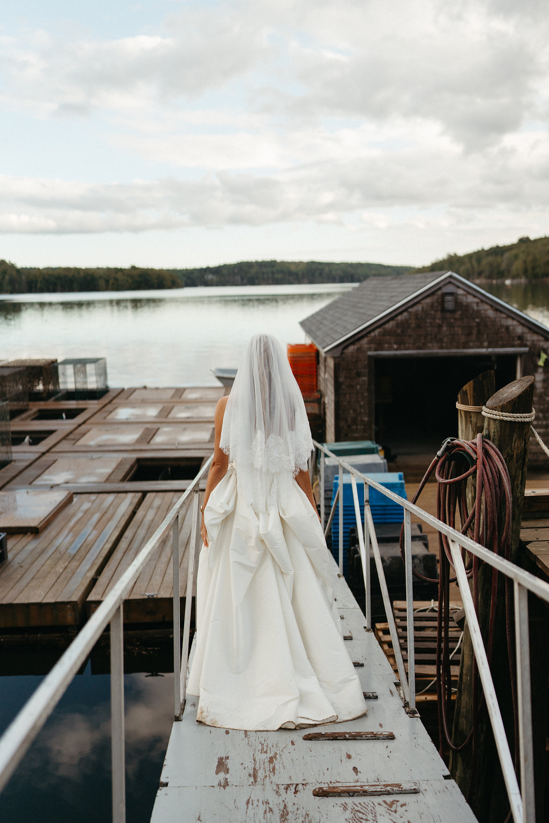 Bride walking down the dock to the ceremony at Glidden Point Oyster Farms