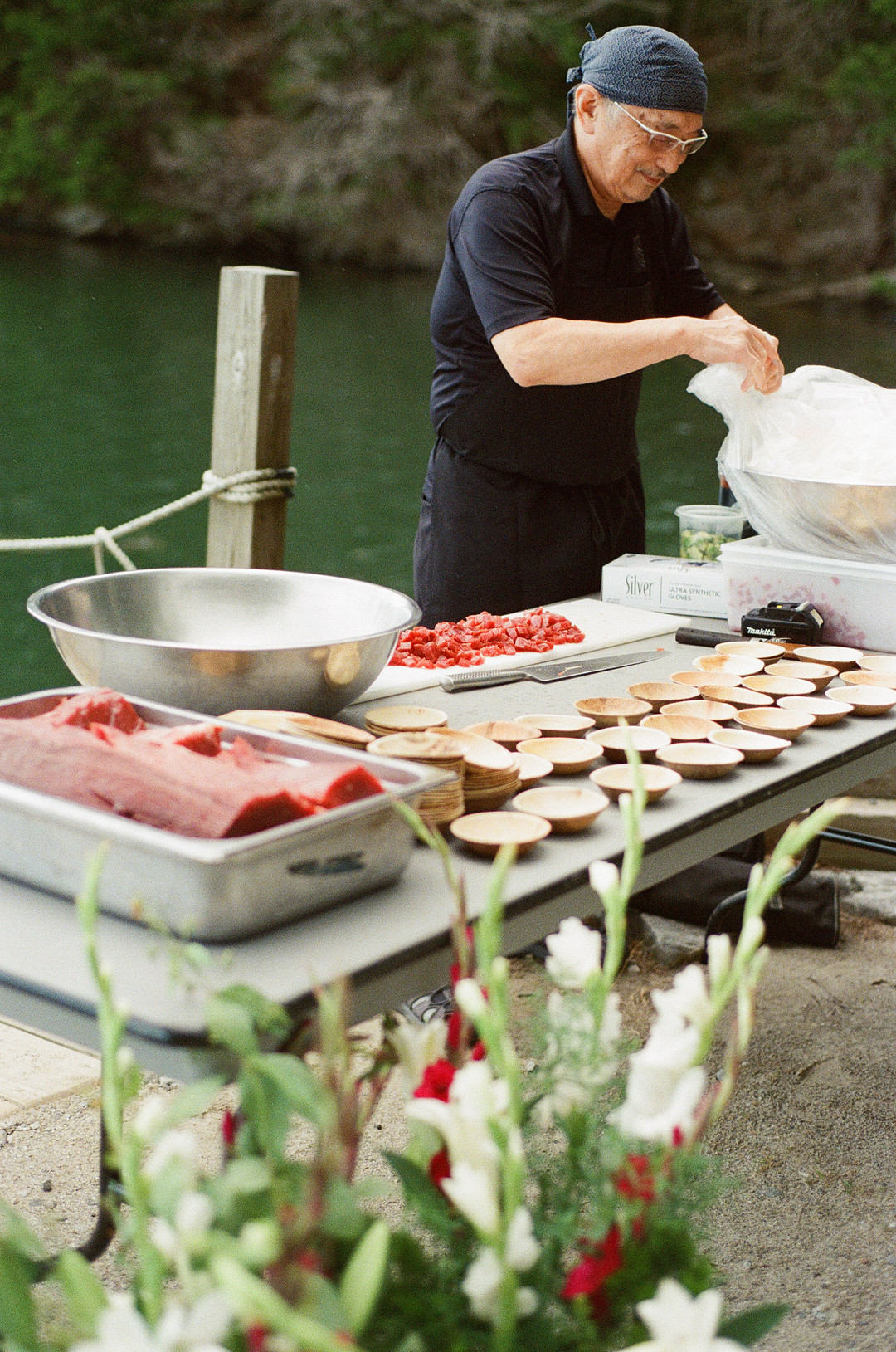 Caterer cutting fresh tuna for guests at cocktail hour