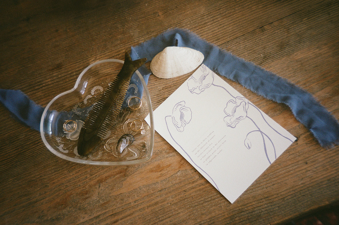 Glass and handwritten card tied with blue ribbon on a wooden table