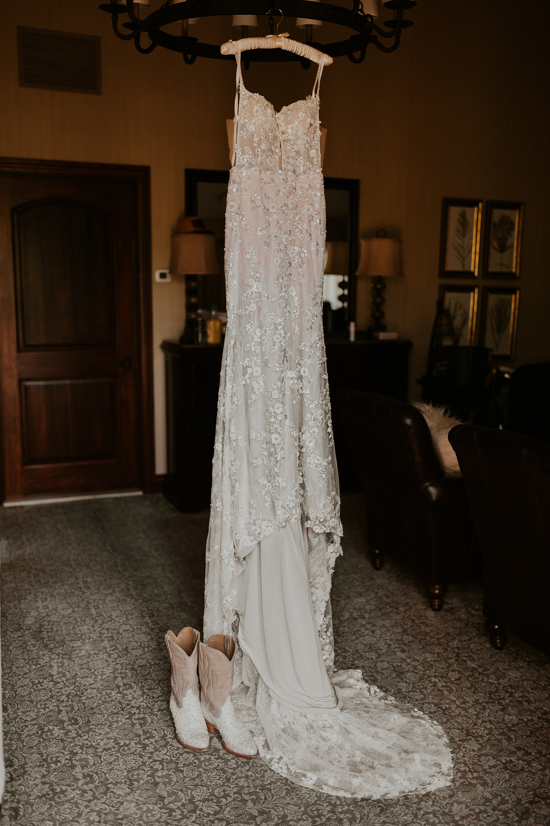 Lace wedding gown hanging in a log cabin