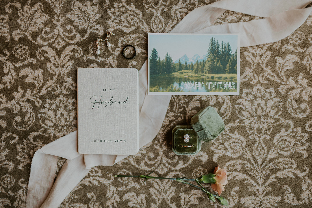 Vow cards and a mountain illustration on a patterned background