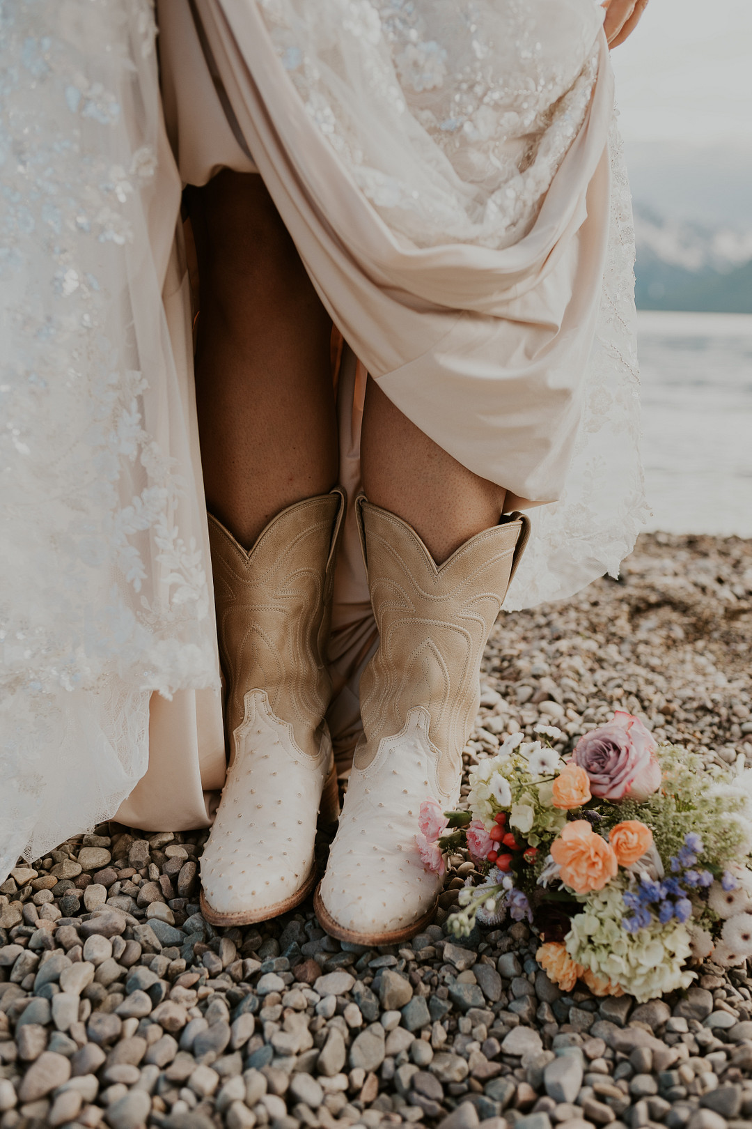 Bride's white cowboy boots peeking out from her gown