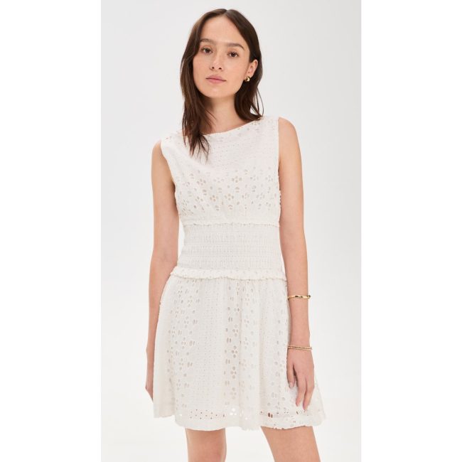 Model in the Hill House Home Joanna dress, a white sleeveless eyelet mini with a drop waist
