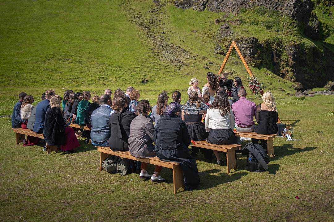 Guests seated on benches for the outdoor ceremony