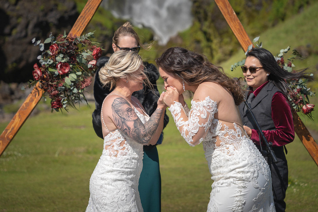 The couple laughing with their officiant during the ceremony