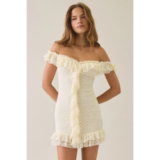 Model in the Kimchi Blue Feels Right off-the-shoulder mini dress in cream lace with ruffle trim along the neckline and down the front