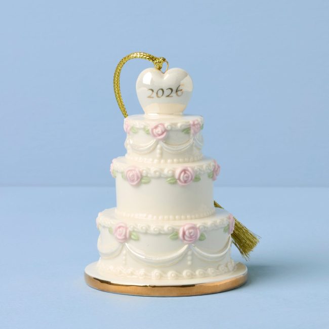 Lenox 2026 porcelain ornament shaped like a three-tier white wedding cake with pink flowers