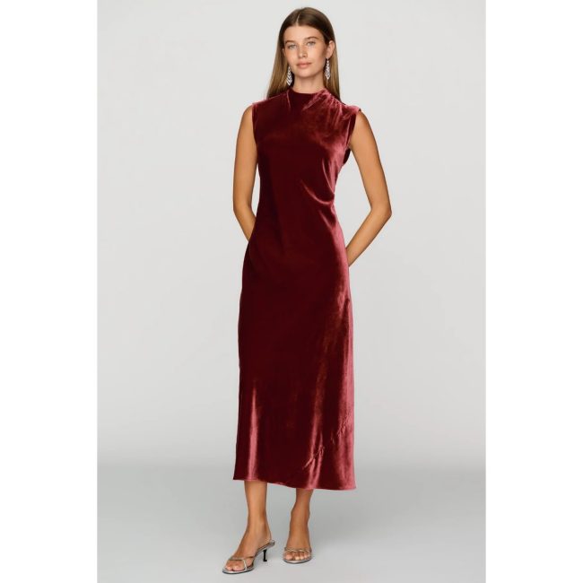 Model in the Maeve Charlette sleeveless velvet midi dress in deep red with a mock neck