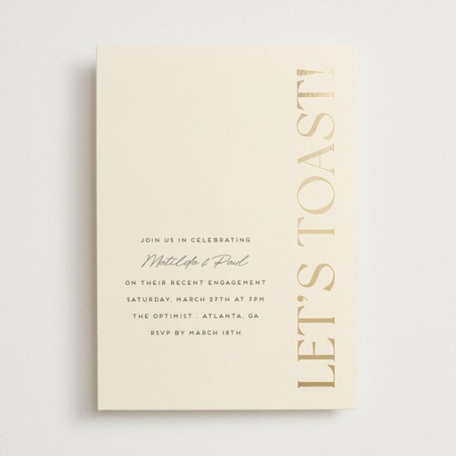 Minted Champagne invitation in ivory with Let's Toast in gold foil along the side
