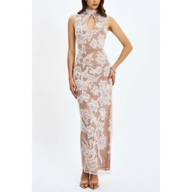 Model in the Miss Circle Tavia maxi dress with white beaded floral embroidery on nude mesh and a keyhole neckline