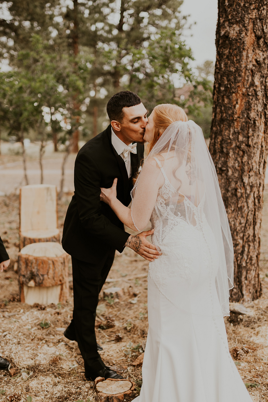 Bride and groom embracing among the pines near Ouray, Colorado