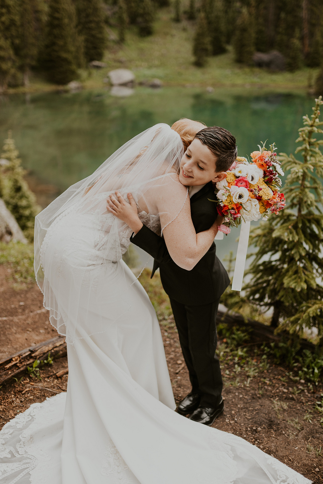 Groom dipping the bride for a kiss by the lake