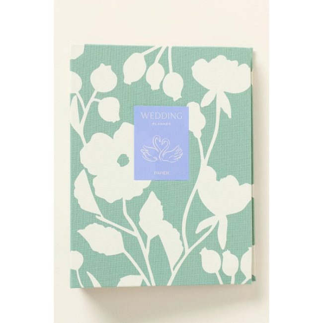 Papier x Anthropologie wedding planner with a green and white floral fabric cover
