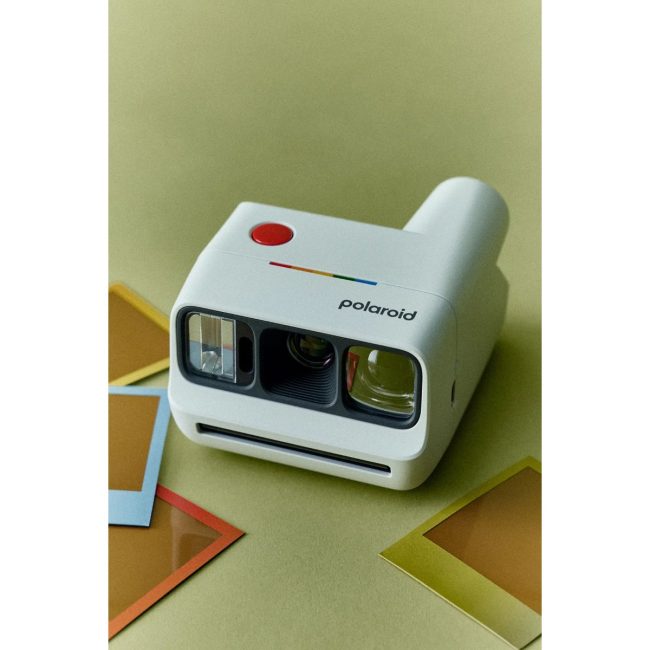 White Polaroid Go Generation 3 instant camera on a green surface