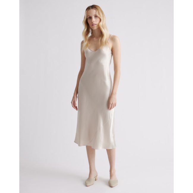 Model in the Quince washable silk slip dress in champagne, a bias-cut midi with thin straps