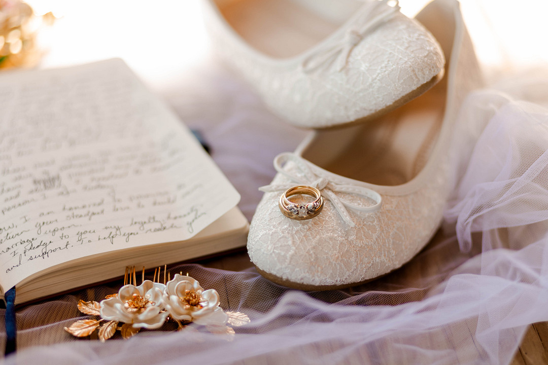 Bridal shoes and a handwritten letter on a table