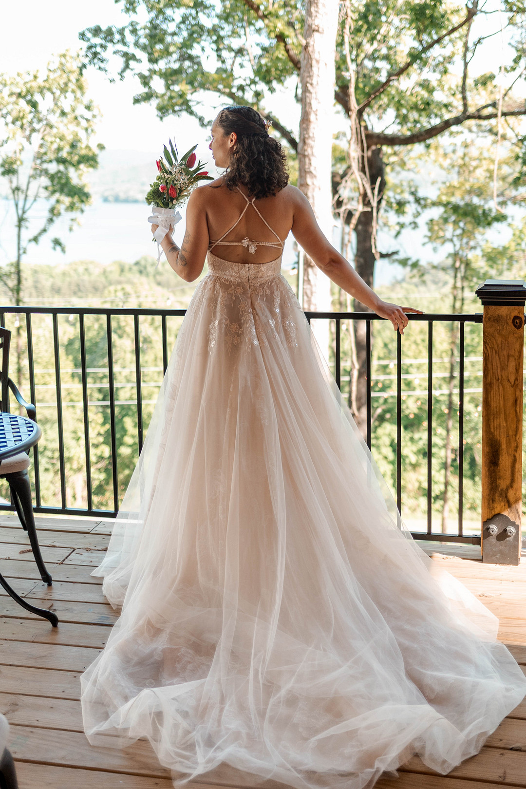Bride on the cabin deck looking out over the trees