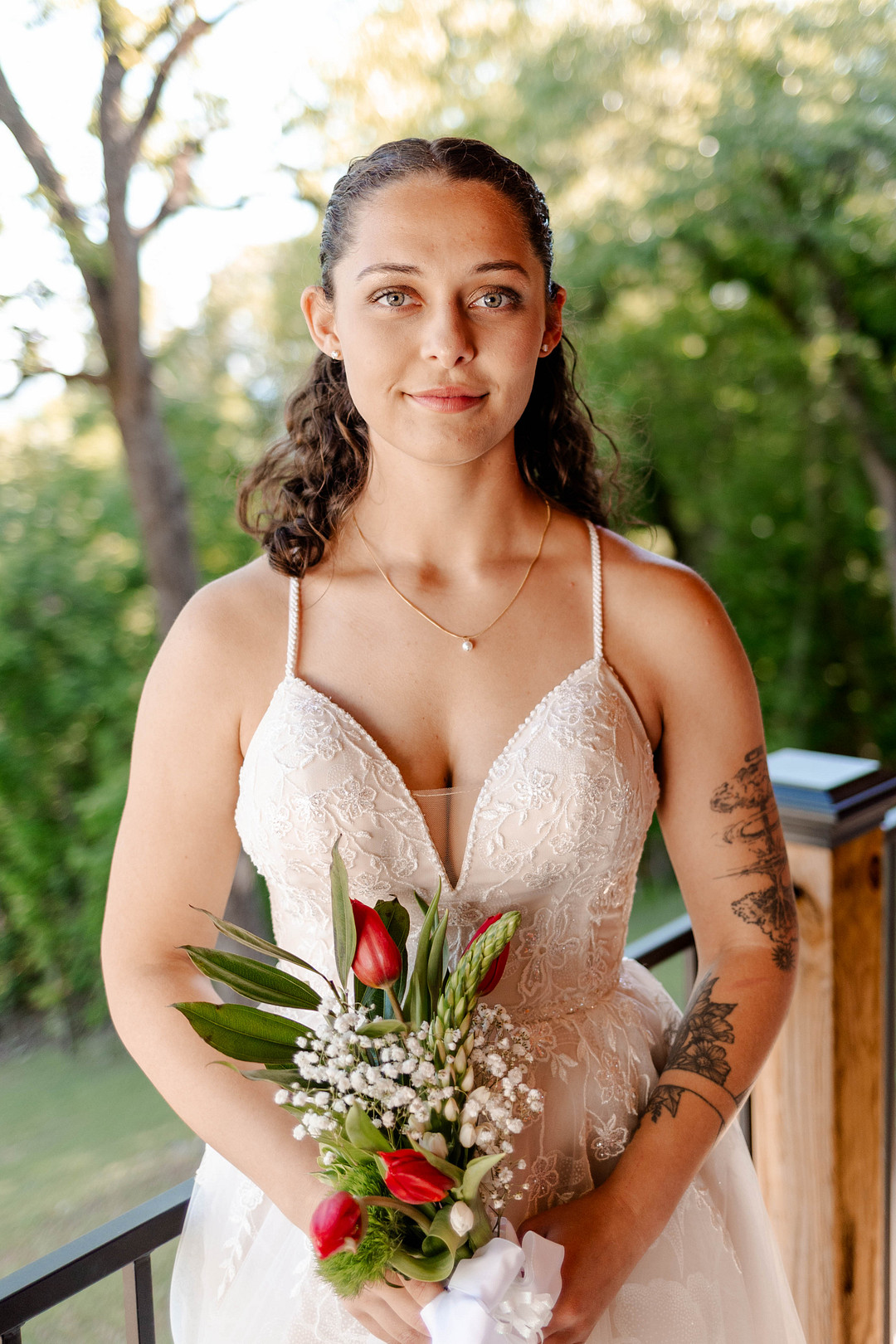 Bride holding a bouquet of red roses and white flowers