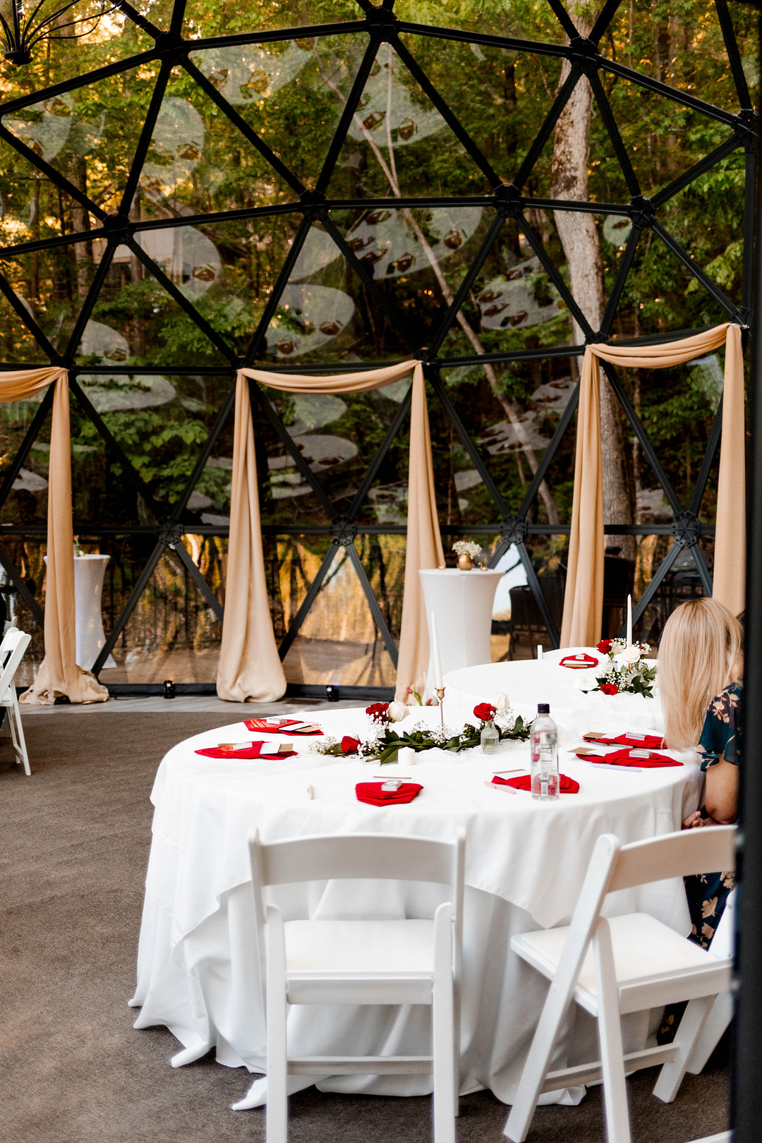Inside the Star Dome set with white tables and a draped arch