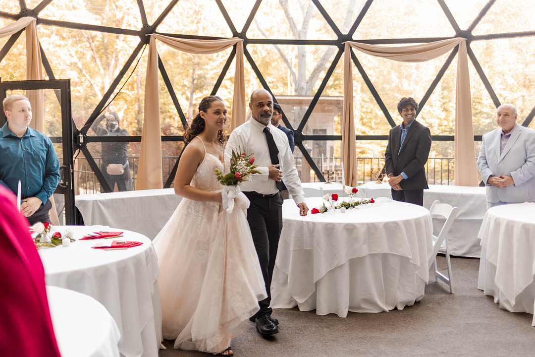 Bride walking down the aisle inside the Star Dome