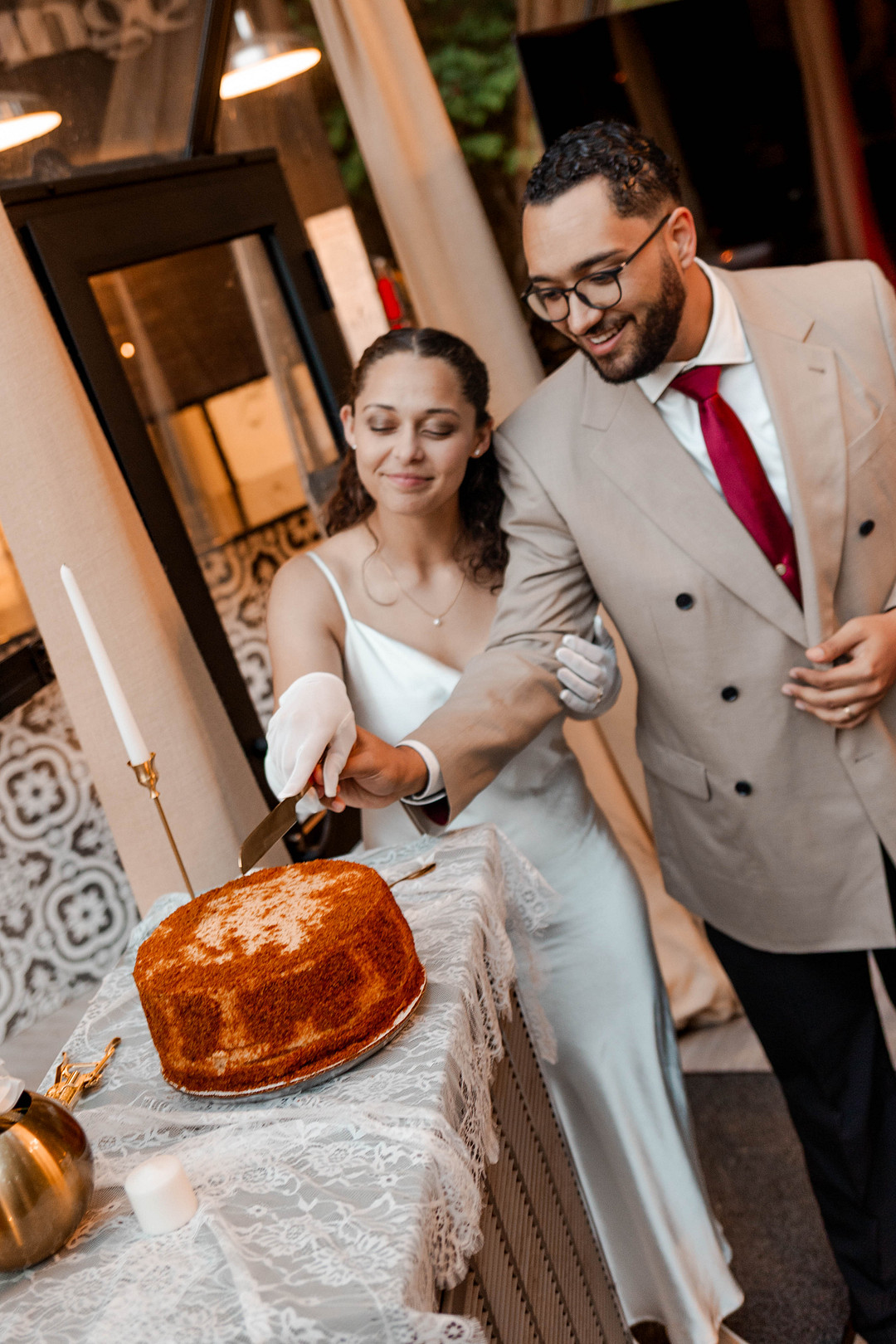 Bride and groom cutting their cake at the reception