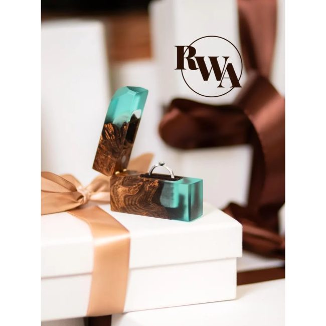 RWAresinwoodart slim wood ring box with an aqua resin stripe, on a gift box tied with a satin bow