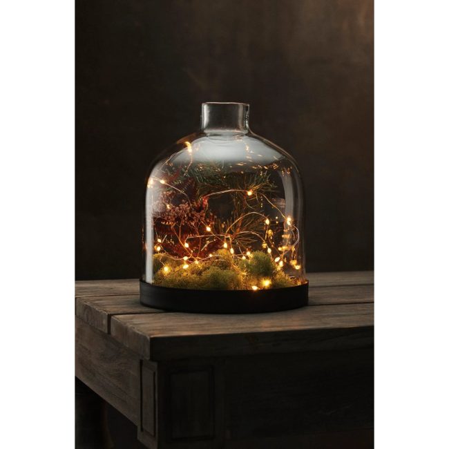 Terrain rose gold twine lights glowing inside a glass cloche