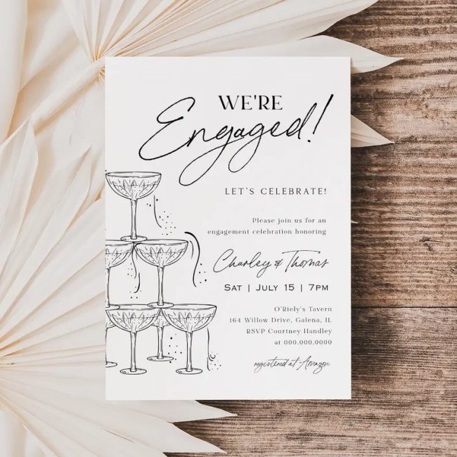 WillowLanePaperie We're Engaged invitation with a sketched champagne tower